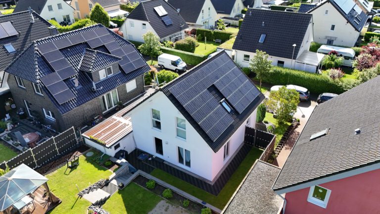 Luftaufnahme einer Photovoltaikanlage, die auf dem Dach eines Gebäudes montiert ist