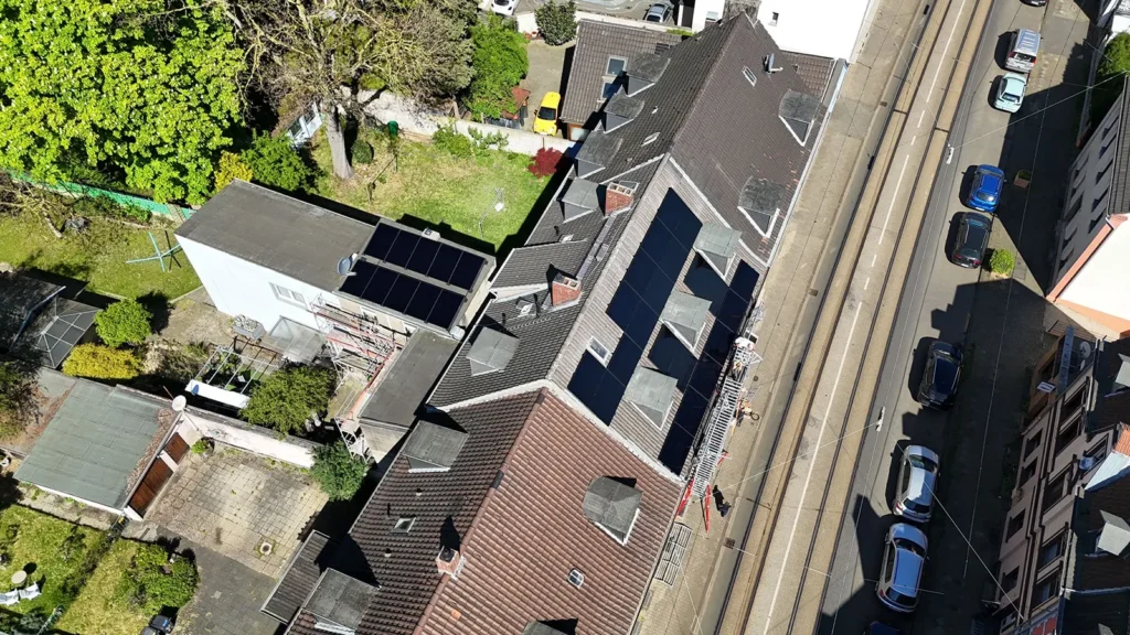 Drohnen-Aufnahme der Solar-Anlage auf dem Dach des mehrstöckigen Mietshauses